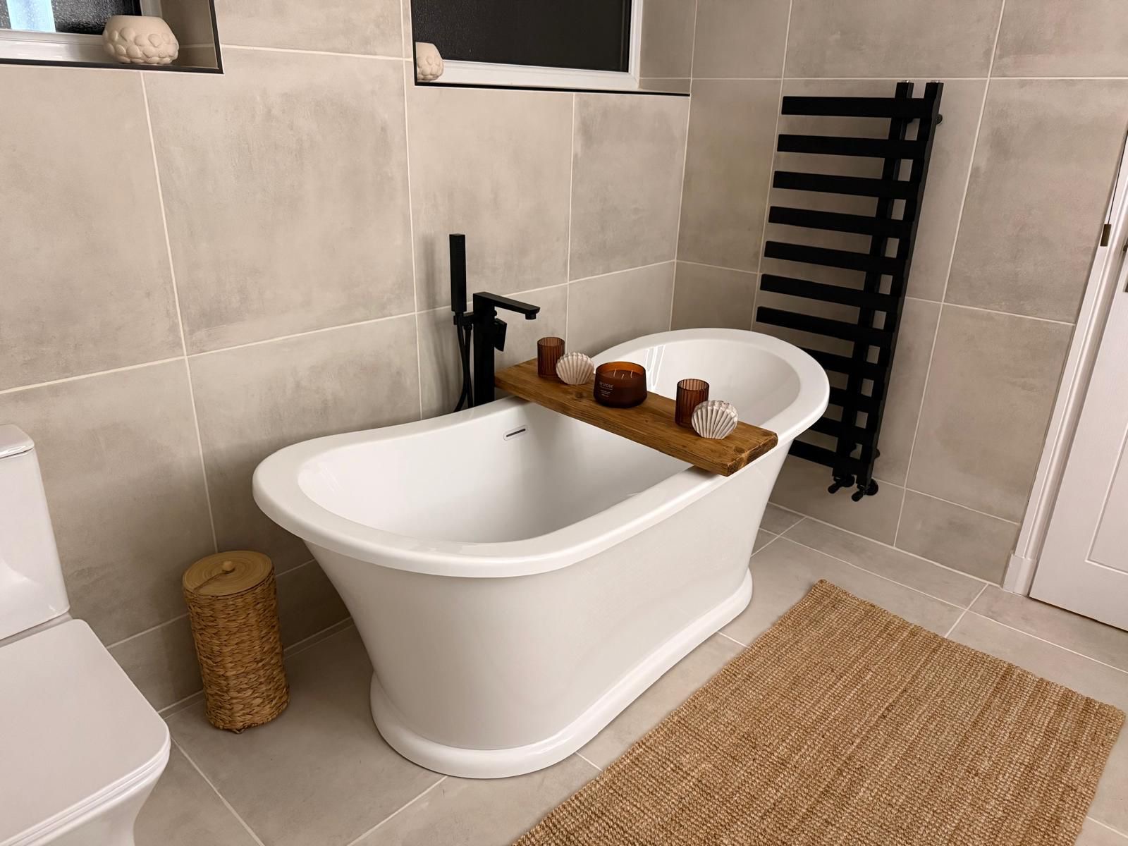 Luxury stone-clad bathroom with freestanding bath
