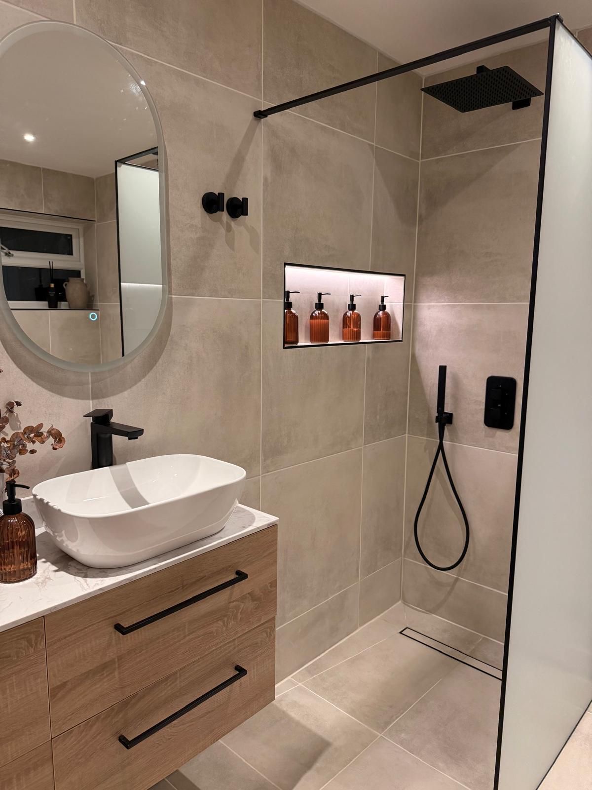 Shower room with black taps, backlit niche and walk-in shower